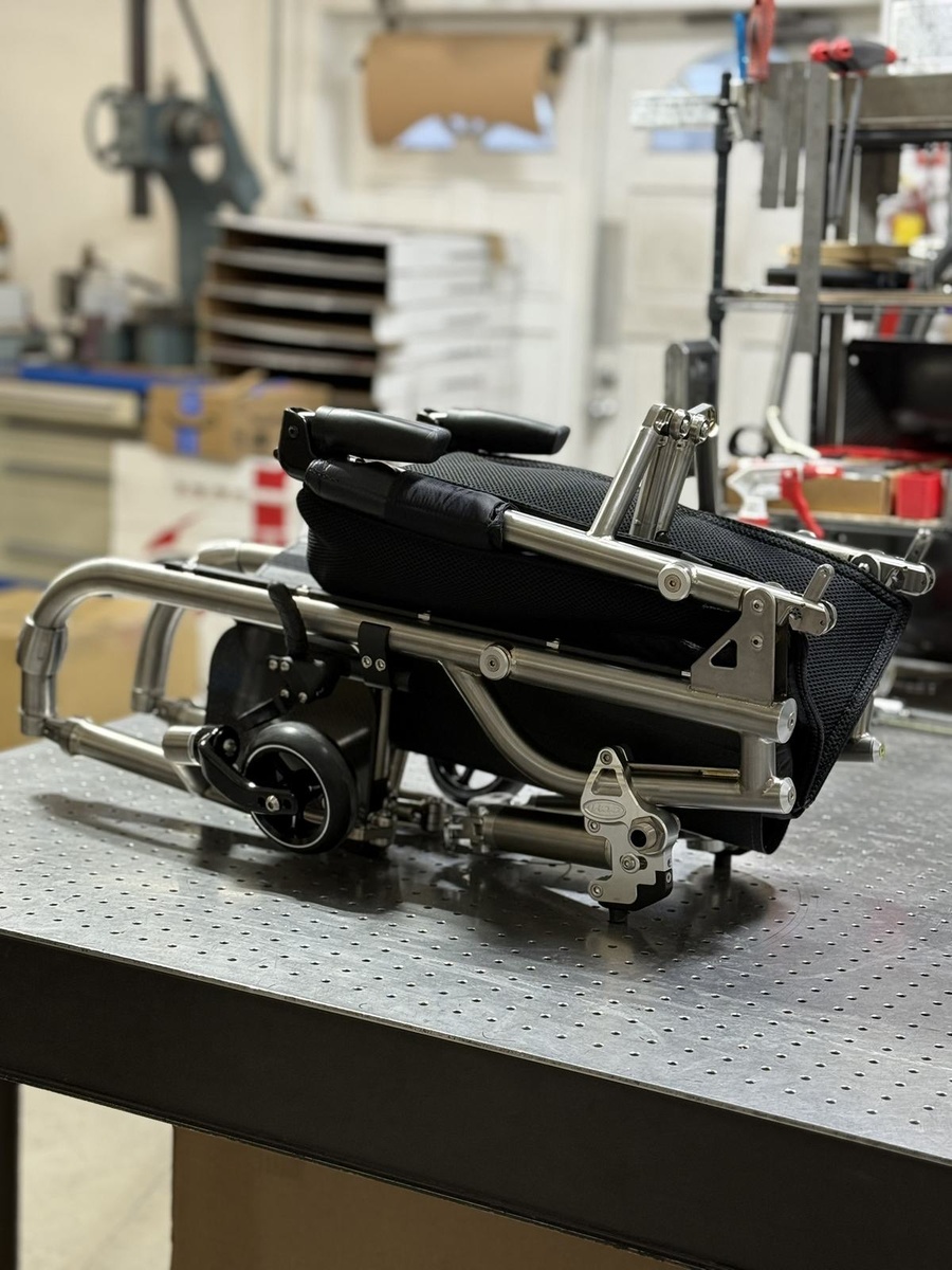A travel-ready HOC wheelchair with folding or coupler features.