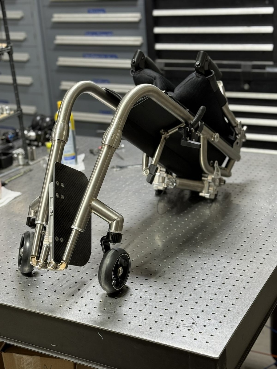 A travel-ready HOC wheelchair with folding or coupler features.