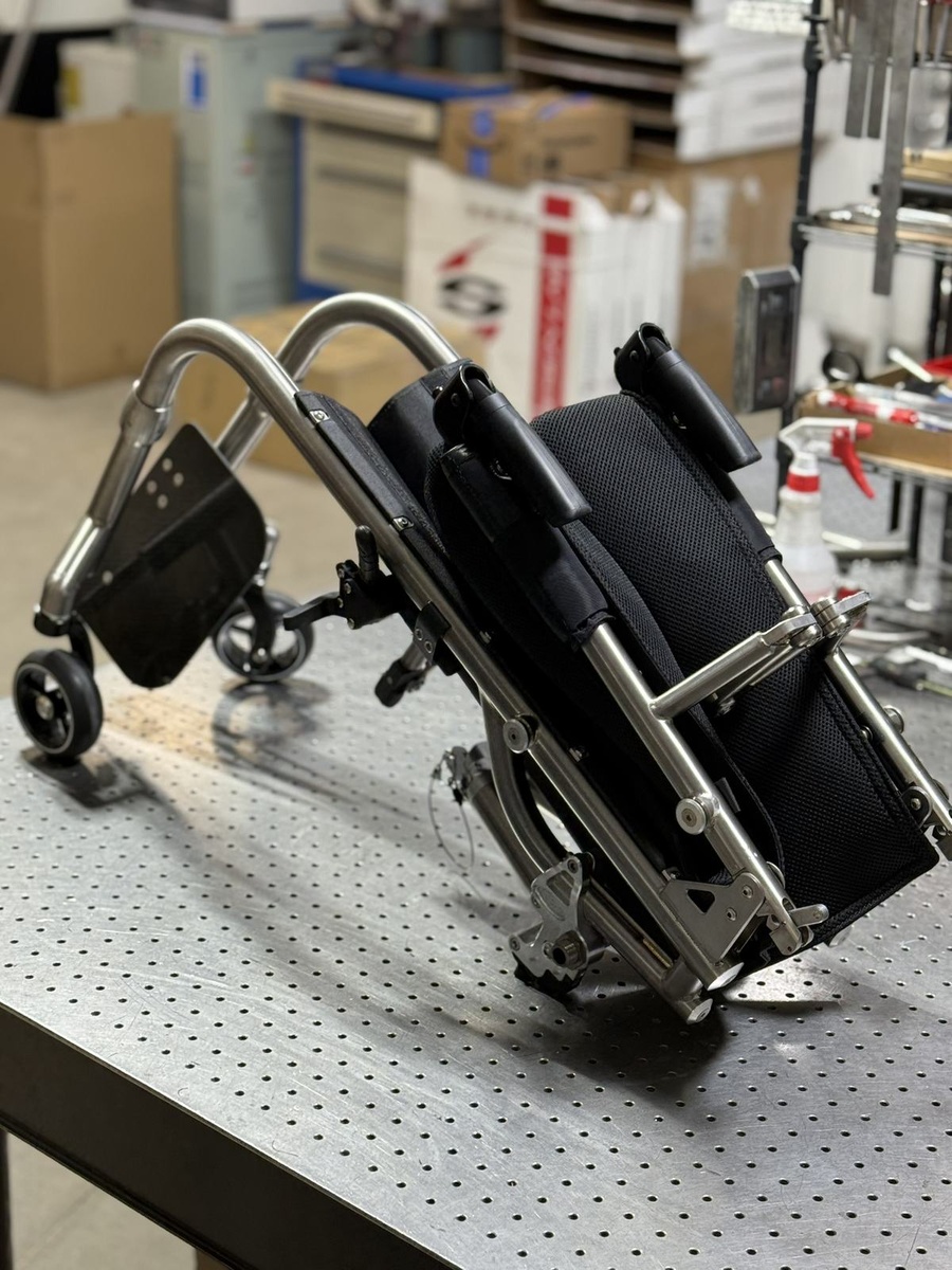 A travel-ready HOC wheelchair with folding or coupler features.