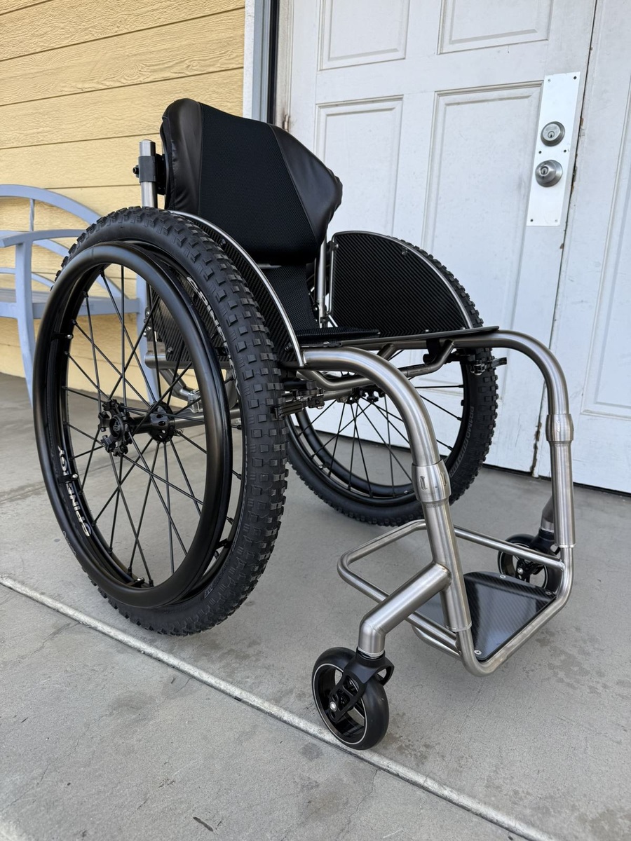 A travel-ready HOC wheelchair with folding or coupler features.