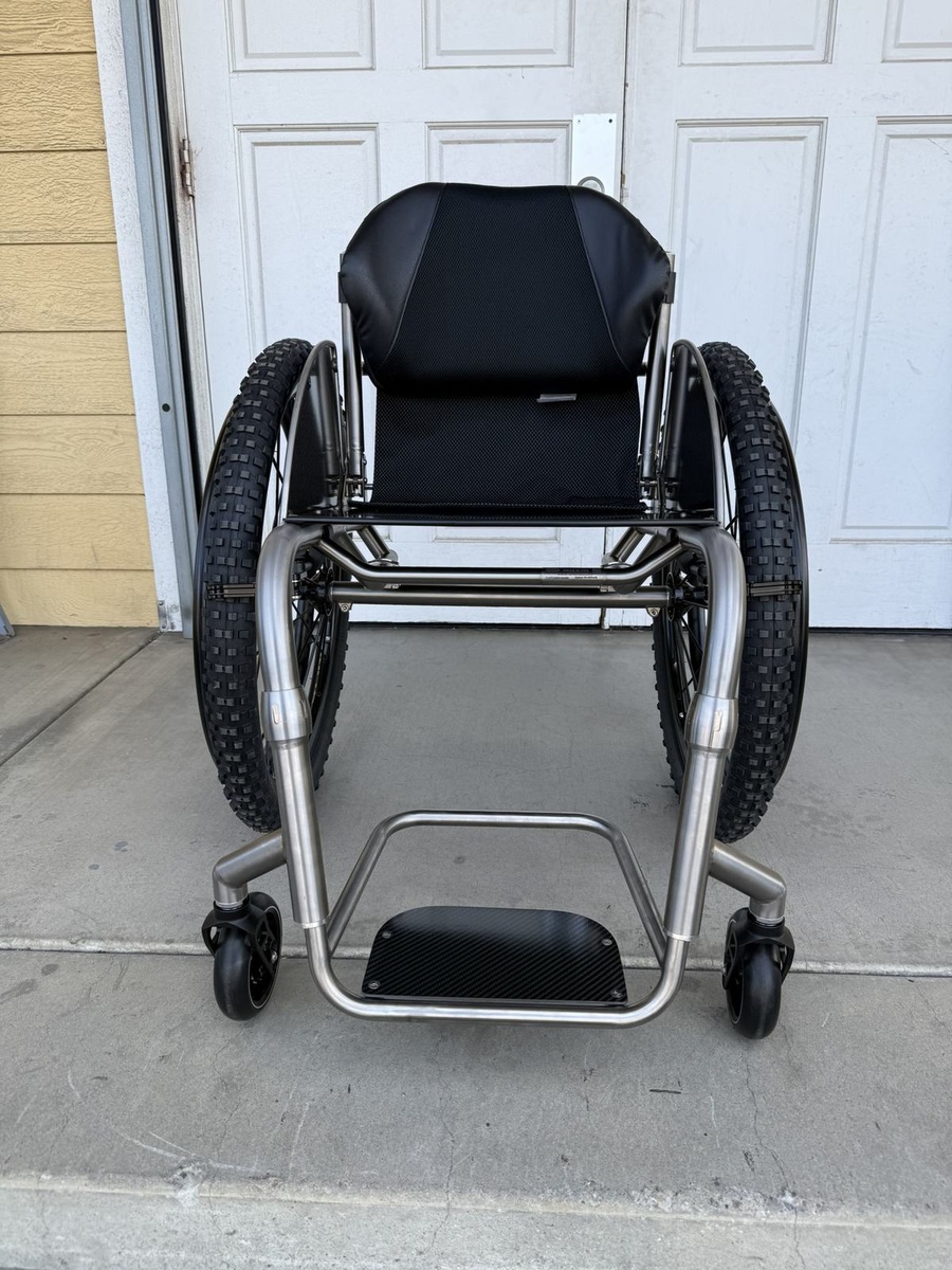 A travel-ready HOC wheelchair with folding or coupler features.