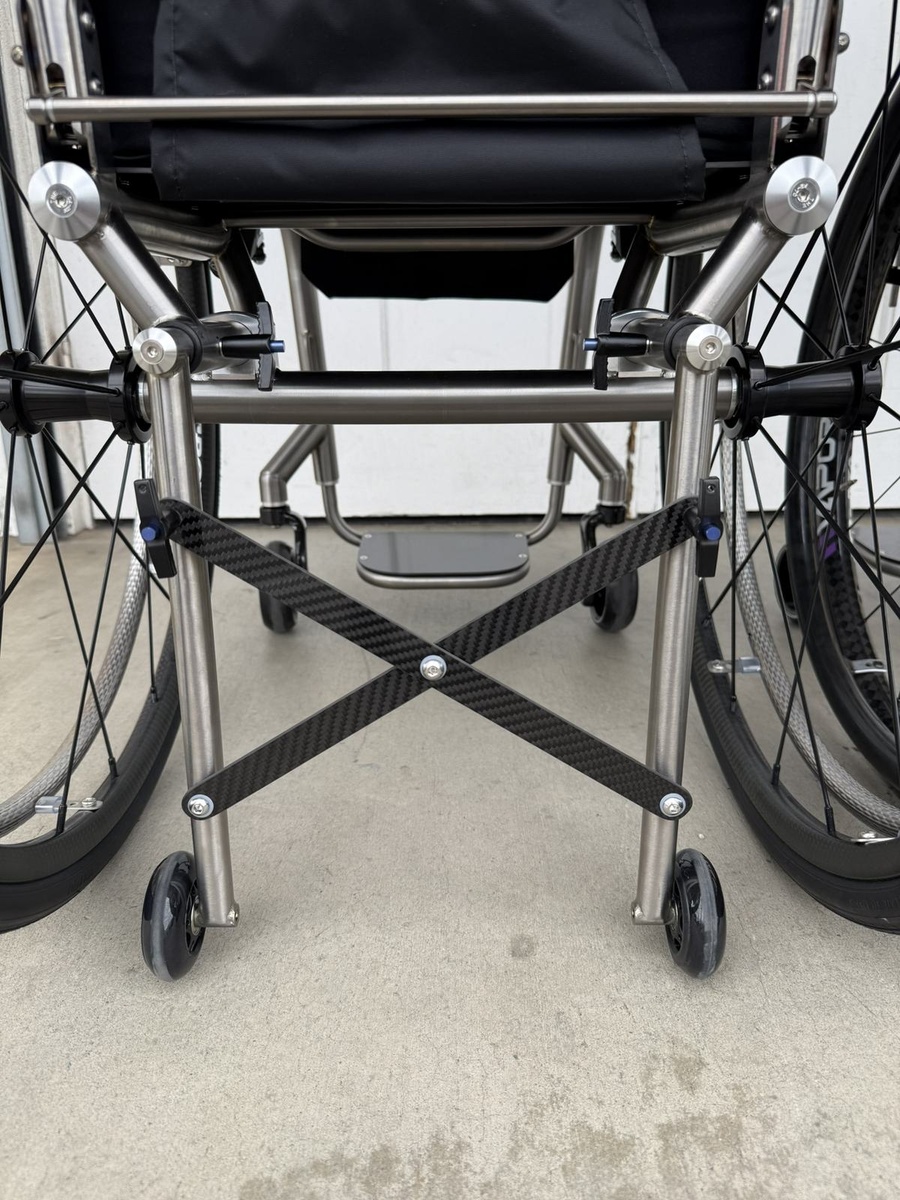 A travel-ready HOC wheelchair with folding or coupler features.