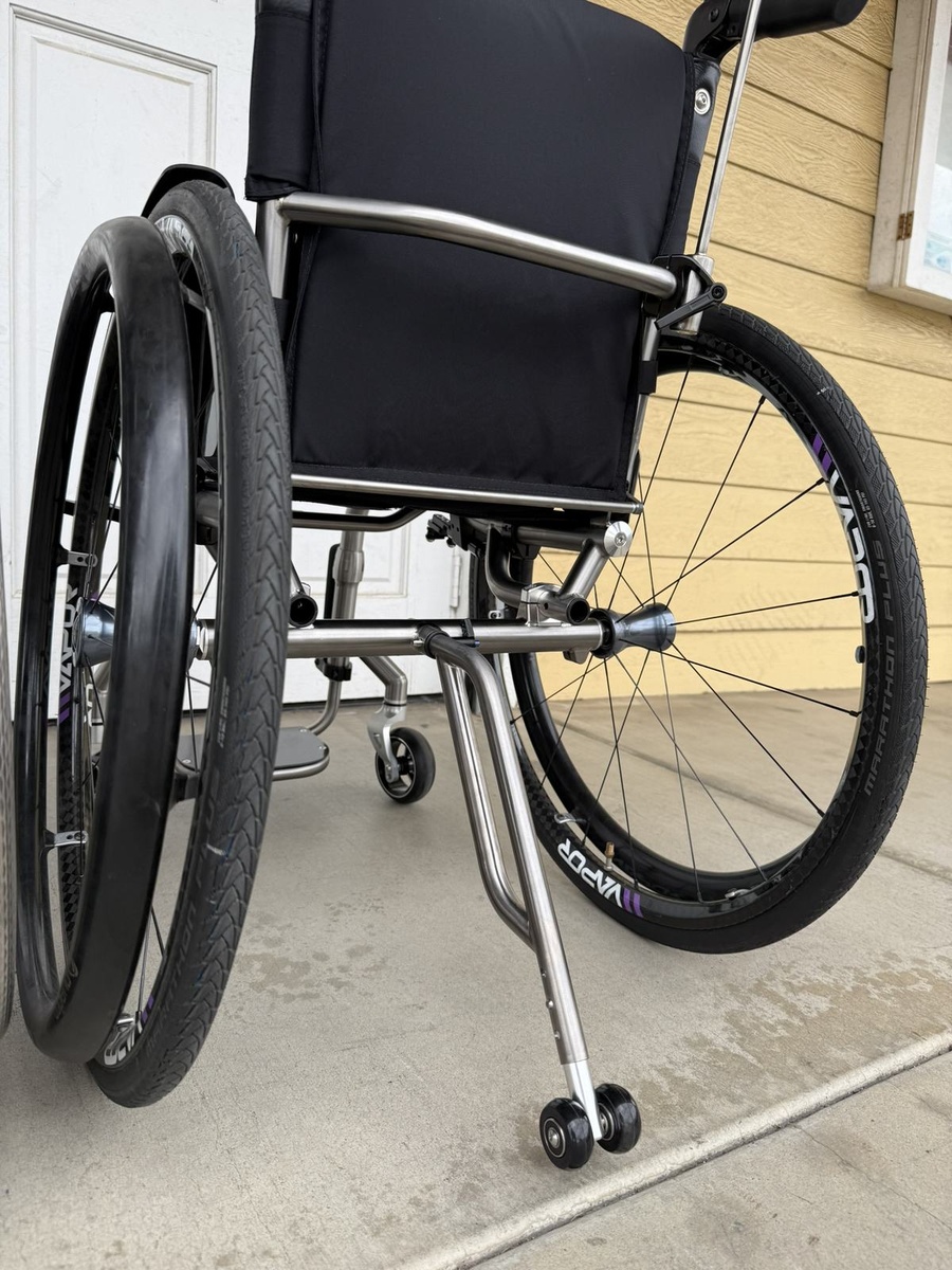 A travel-ready HOC wheelchair with folding or coupler features.