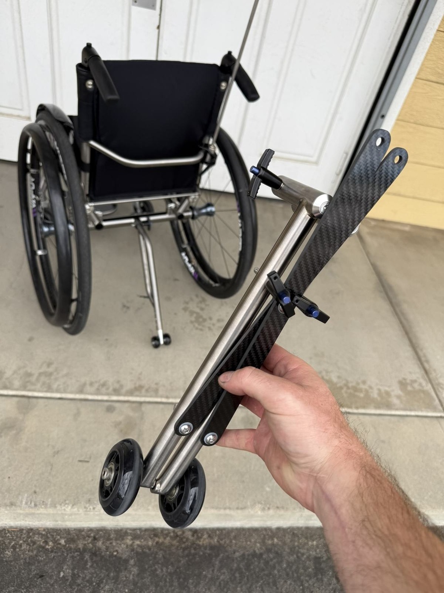 A travel-ready HOC wheelchair with folding or coupler features.