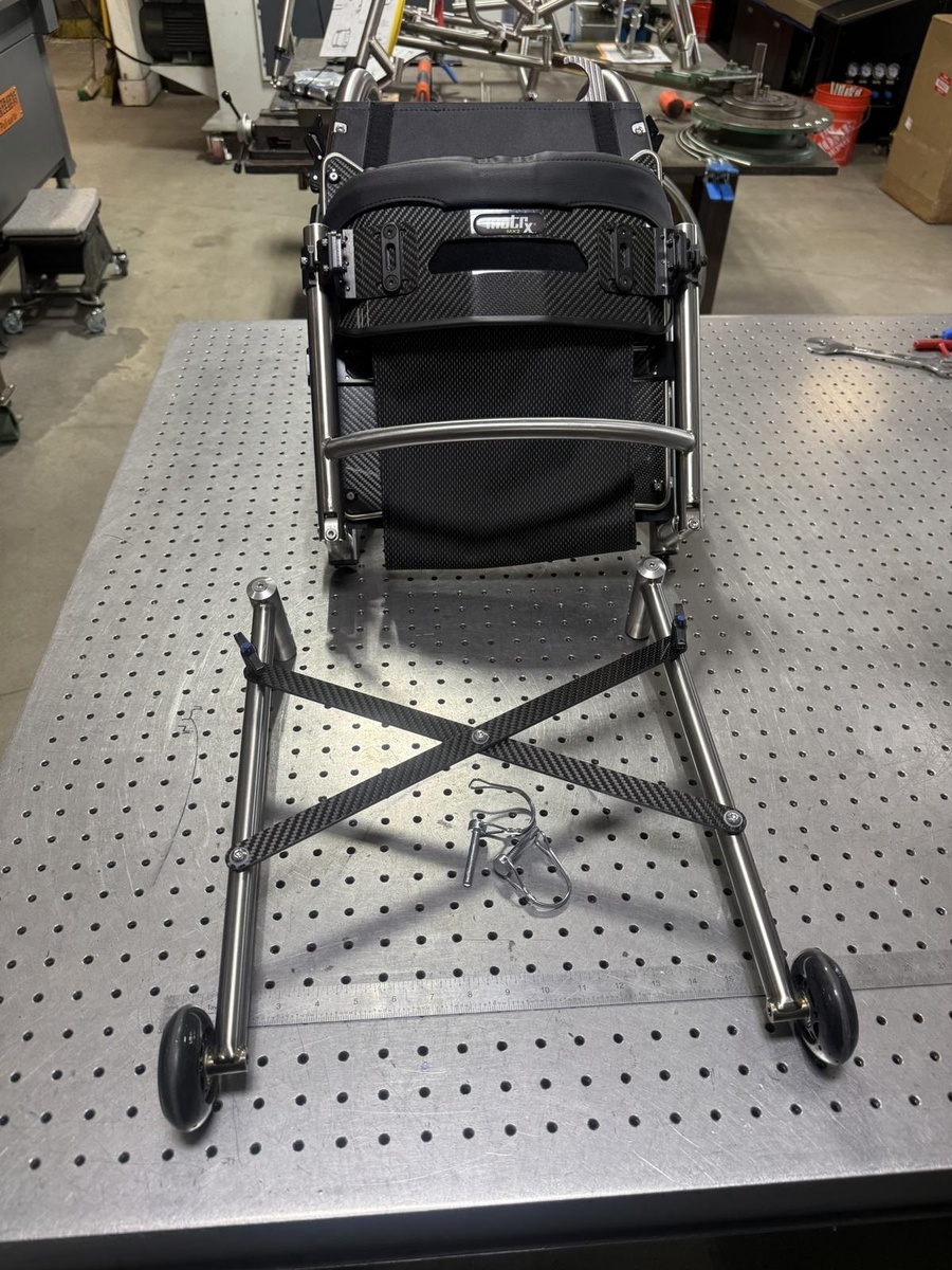 A travel-ready HOC wheelchair with folding or coupler features.