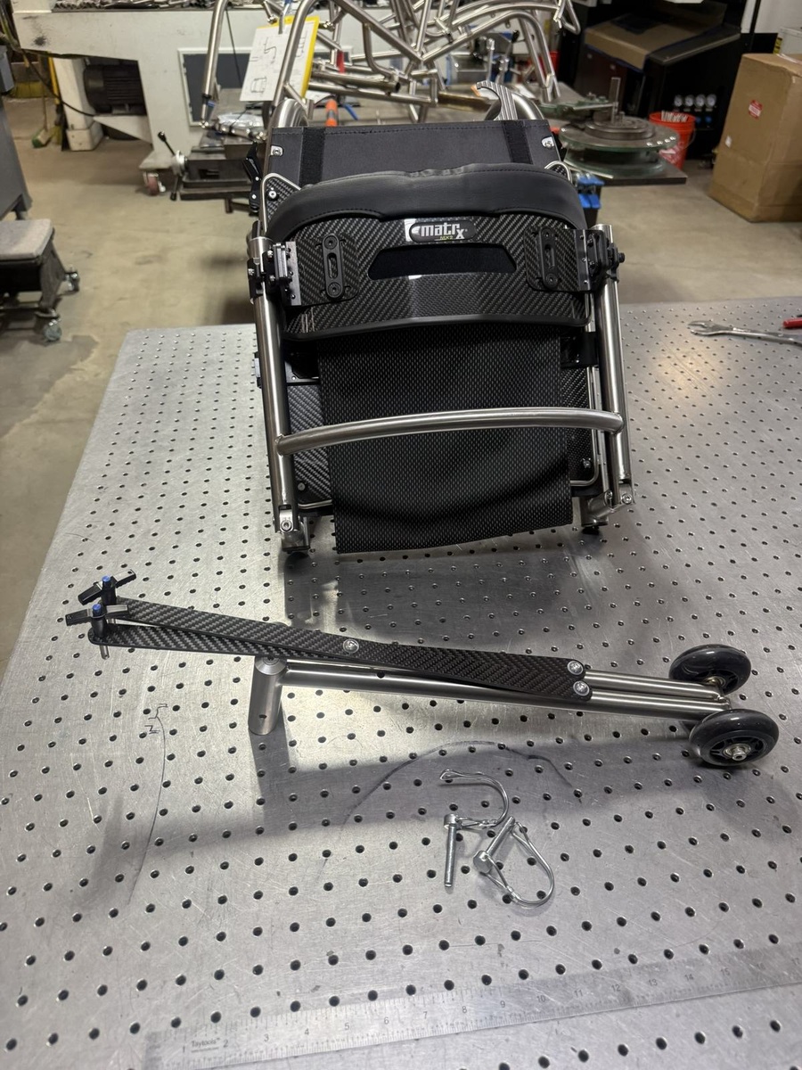 A travel-ready HOC wheelchair with folding or coupler features.